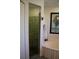 Bathroom with glass enclosed shower and soaking tub at 18135 Lake Worth Blvd, Port Charlotte, FL 33948