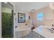 Well-lit bathroom with a tub, walk-in shower and a vanity with a sleek sink at 18135 Lake Worth Blvd, Port Charlotte, FL 33948