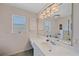 Bright bathroom with a large mirror, vanity with ample counter space and dual windows at 18135 Lake Worth Blvd, Port Charlotte, FL 33948