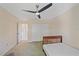 Clean bedroom with a ceiling fan, carpet and a large closet at 18135 Lake Worth Blvd, Port Charlotte, FL 33948