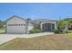 Charming single-story home with a well-manicured lawn and attached two-car garage at 18135 Lake Worth Blvd, Port Charlotte, FL 33948