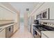 Efficient kitchen layout with stainless steel appliances and ample cabinet space at 18135 Lake Worth Blvd, Port Charlotte, FL 33948