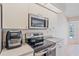 Modern kitchen appliances including a stainless steel microwave and electric stovetop at 18135 Lake Worth Blvd, Port Charlotte, FL 33948