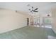 Spacious living room featuring tile flooring and a ceiling fan for added comfort at 18135 Lake Worth Blvd, Port Charlotte, FL 33948