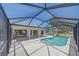 Screened-in pool area with a pool, patio space and palm trees at 18135 Lake Worth Blvd, Port Charlotte, FL 33948