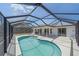 Inviting screened-in pool with a large pool, patio space and an outdoor grill at 18135 Lake Worth Blvd, Port Charlotte, FL 33948