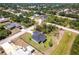 Aerial view of the property in a beautiful neighborhood with lush, mature landscaping at 1816 Braddock Ave, North Port, FL 34288