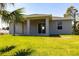 Home's backyard with lush lawn and covered patio, providing a great outdoor space at 1816 Braddock Ave, North Port, FL 34288