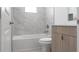 Bright bathroom featuring a tub with marble wall tiles, a new toilet, and modern vanity at 1816 Braddock Ave, North Port, FL 34288