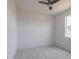 Simple bedroom design with light floors, a ceiling fan, and natural light from the window at 1816 Braddock Ave, North Port, FL 34288