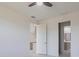 Bright bedroom with light-tone floors, ceiling fan and doorway view into kitchen and bathroom at 1816 Braddock Ave, North Port, FL 34288