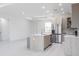 Spacious kitchen with modern island, stainless steel appliances, and open concept design at 1816 Braddock Ave, North Port, FL 34288