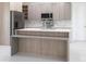 Modern kitchen with stainless appliances, a large kitchen island and marble backsplash at 1816 Braddock Ave, North Port, FL 34288