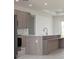Modern kitchen with stainless steel appliances, island and stylish wood grain cabinets at 1816 Braddock Ave, North Port, FL 34288