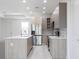 Stylish kitchen with stainless steel appliances, a center island, and modern wood-look cabinets at 1816 Braddock Ave, North Port, FL 34288