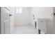 Well lit Laundry room with utilitarian sink, window and washer and dryer hookups at 1816 Braddock Ave, North Port, FL 34288