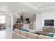 Spacious living room with modern kitchen island featuring granite countertop and stainless appliances at 1816 Braddock Ave, North Port, FL 34288