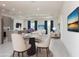 Spacious living room with dining area, recessed lighting, and two large TVs in the home at 1816 Braddock Ave, North Port, FL 34288