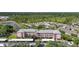 An aerial view of the building with water and mature trees surrounding it at 2061 Willow Hammock Cir # 303, Punta Gorda, FL 33983