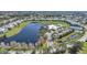 Aerial view of a community with a lake, clubhouse, pool, and tennis courts at 2061 Willow Hammock Cir # 303, Punta Gorda, FL 33983