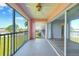 Screened balcony with a ceiling fan and a view toward the interior of the home at 2061 Willow Hammock Cir # 303, Punta Gorda, FL 33983