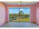 A screened-in balcony with a ceiling fan offering beautiful views of the lush green landscape at 2061 Willow Hammock Cir # 303, Punta Gorda, FL 33983