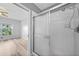 En suite bathroom with tile surround shower and open view to the bedroom at 2061 Willow Hammock Cir # 303, Punta Gorda, FL 33983