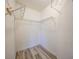 Walk-in closet with white walls and metal shelving for storage at 2061 Willow Hammock Cir # 303, Punta Gorda, FL 33983