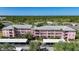 Three-story condominiums with lush landscaping, covered parking, and exterior stairway access at 2061 Willow Hammock Cir # 303, Punta Gorda, FL 33983
