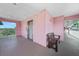 A light and bright exterior hall featuring a bench and views of tropical greenery at 2061 Willow Hammock Cir # 303, Punta Gorda, FL 33983