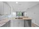 Charming kitchen with stone countertops, modern appliances and an inviting view to the outdoor balcony at 2061 Willow Hammock Cir # 303, Punta Gorda, FL 33983