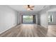 Bright living room with neutral colors, wood-look flooring, and balcony access at 2061 Willow Hammock Cir # 303, Punta Gorda, FL 33983
