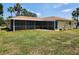 Spacious backyard featuring a large screened-in patio area at 21035 Exmore Ave, Port Charlotte, FL 33952