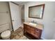 Bathroom with wood vanity, granite counter, wood mirror and tile floors at 21035 Exmore Ave, Port Charlotte, FL 33952