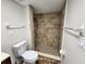 This bathroom features tile, a stand-up shower, a toilet, and a towel rack at 21035 Exmore Ave, Port Charlotte, FL 33952