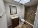 This bathroom features a dark wood vanity, a toilet, and a stand up shower at 21035 Exmore Ave, Port Charlotte, FL 33952