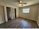 Bedroom showcasing hardwood floors, a ceiling fan, and large closets at 21035 Exmore Ave, Port Charlotte, FL 33952