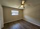 Bedroom featuring hardwood floors, a ceiling fan, and a window at 21035 Exmore Ave, Port Charlotte, FL 33952