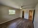 This bedroom features hardwood floors, a closet, and an ensuite bathroom at 21035 Exmore Ave, Port Charlotte, FL 33952