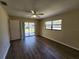 This bedroom features hardwood floors, a fan, and natural light with a sliding glass door at 21035 Exmore Ave, Port Charlotte, FL 33952