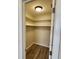 This is a walk in closet with white shelving, and dark wood floors at 21035 Exmore Ave, Port Charlotte, FL 33952