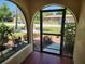 Enclosed front porch area with exterior view of landscaped front yard and home beyond at 21035 Exmore Ave, Port Charlotte, FL 33952