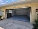 Spacious garage with a painted floor and ample room for vehicles and storage, offering functionality and organization at 21035 Exmore Ave, Port Charlotte, FL 33952