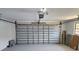 The interior garage has an automated door, with a light grey painted floor. There are also some panes of glass leaning on the wall at 21035 Exmore Ave, Port Charlotte, FL 33952