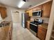Modern kitchen featuring granite countertops, stainless steel appliances, and tile floors at 21035 Exmore Ave, Port Charlotte, FL 33952