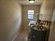 Practical laundry area with washer, dryer, water heater, and a window at 21035 Exmore Ave, Port Charlotte, FL 33952