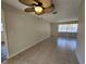 Bright living room featuring tile flooring and a ceiling fan fixture at 21035 Exmore Ave, Port Charlotte, FL 33952