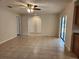 Living room with neutral paint, ceiling fan, and tiled floors; doorways to other rooms at 21035 Exmore Ave, Port Charlotte, FL 33952