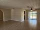 Large living room area featuring tiled floors, neutral paint, and sliding glass doors to backyard at 21035 Exmore Ave, Port Charlotte, FL 33952