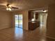 The living room features sliding glass doors and flows into the updated kitchen at 21035 Exmore Ave, Port Charlotte, FL 33952